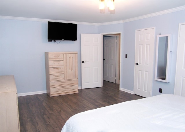 bedroom with crown molding, baseboards, and dark wood-style flooring