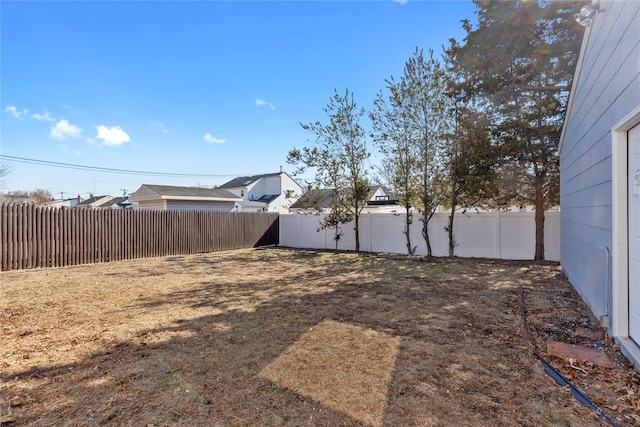 view of yard with a fenced backyard