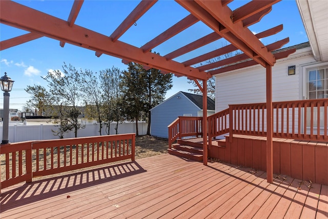 wooden deck featuring fence and a pergola