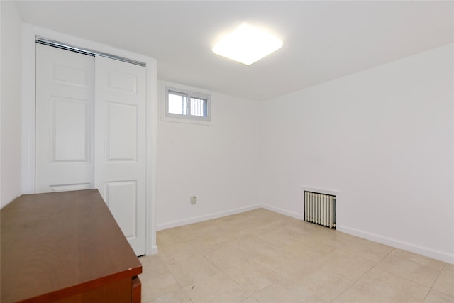 interior space featuring radiator and baseboards