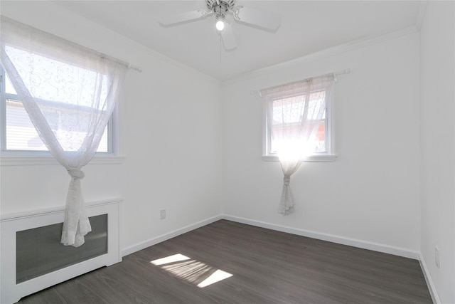 unfurnished room with ornamental molding, dark wood-style flooring, and plenty of natural light