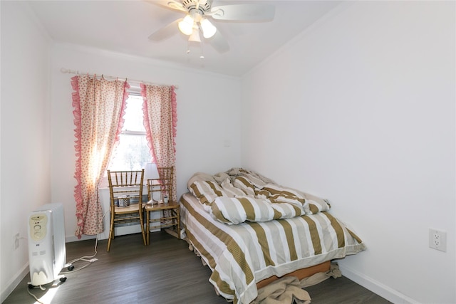 bedroom with ornamental molding, dark wood-style flooring, and baseboards