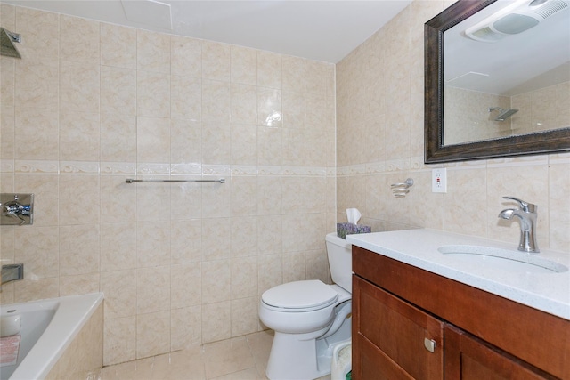 full bathroom with toilet, tile patterned floors, tiled shower / bath combo, vanity, and tile walls