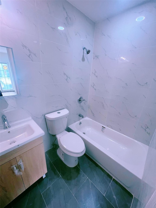 full bathroom featuring shower / bath combination, vanity, toilet, and tile walls