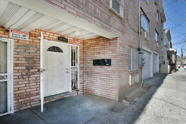 view of exterior entry featuring brick siding