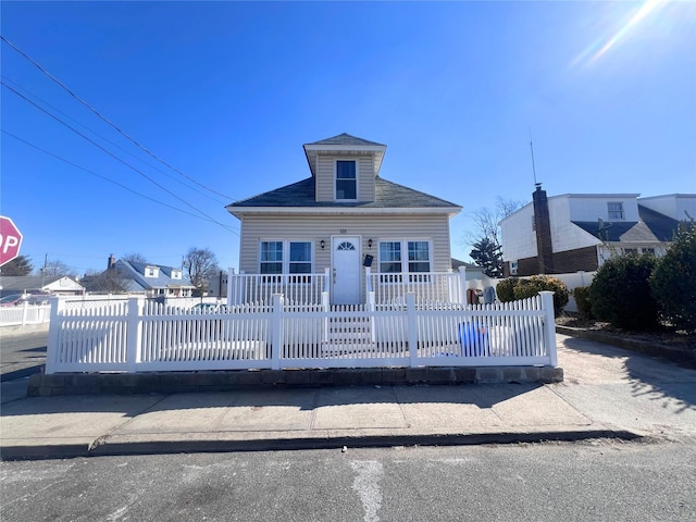 bungalow featuring a porch and a fenced front yard