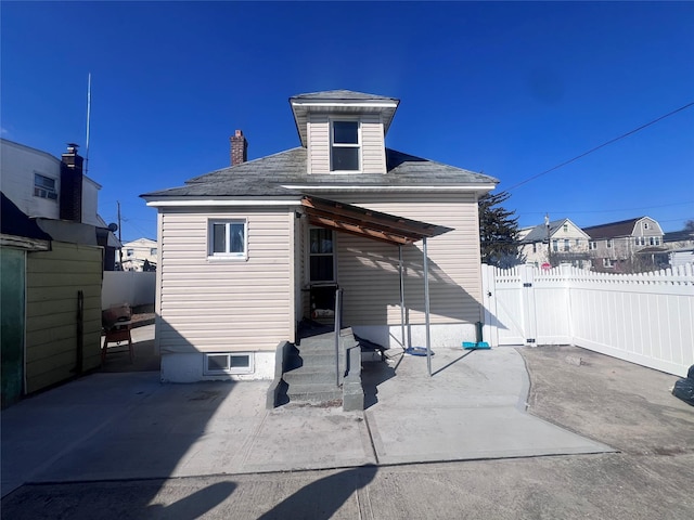 back of property featuring a gate, a patio, and fence