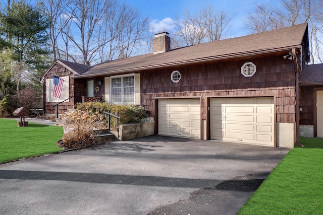 view of front of home featuring a chimney, a shingled roof, an attached garage, driveway, and a front lawn