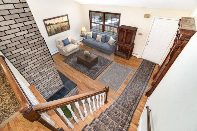 living area featuring baseboard heating and wood finished floors