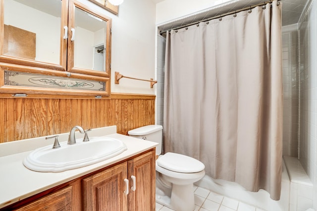 bathroom with toilet, wood walls, vanity, wainscoting, and a shower with curtain