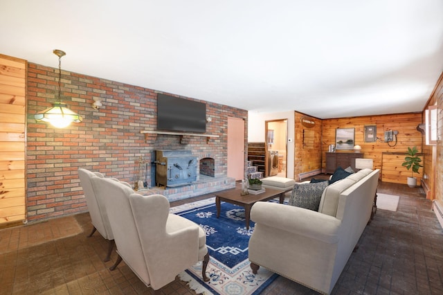 living area with brick floor, wood walls, baseboard heating, and a wood stove