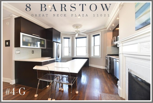 kitchen featuring appliances with stainless steel finishes, light countertops, a peninsula, and ornamental molding