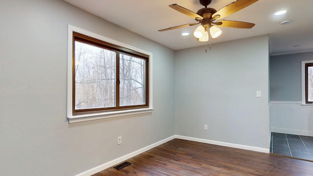 empty room with baseboards, visible vents, dark wood-style floors, ceiling fan, and recessed lighting