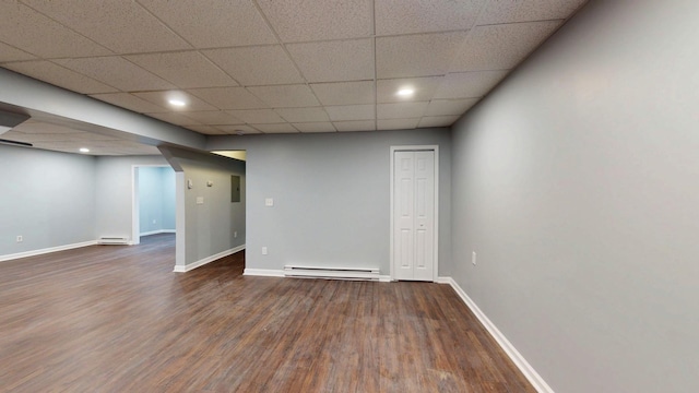 below grade area featuring baseboards, a baseboard heating unit, baseboard heating, and wood finished floors