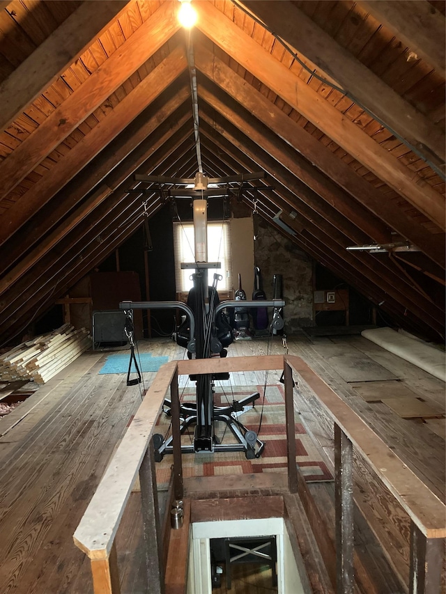 unfinished attic featuring an upstairs landing