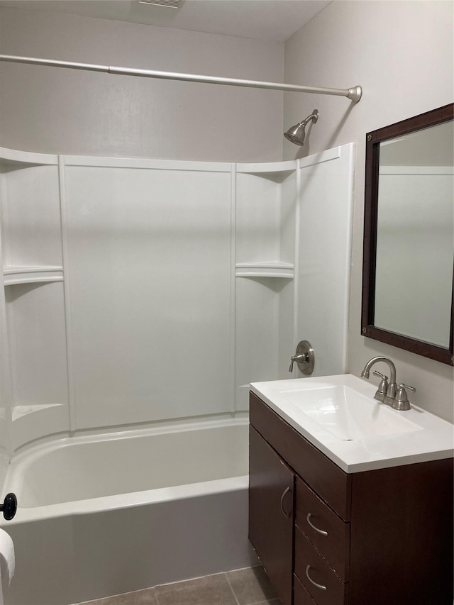 bathroom with shower / tub combination, vanity, and tile patterned floors