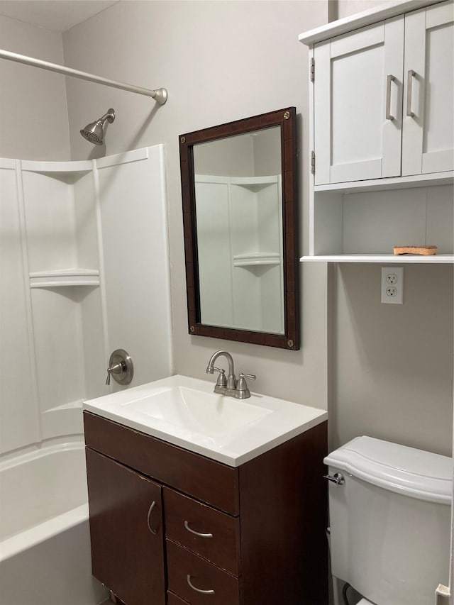 bathroom featuring washtub / shower combination, vanity, and toilet