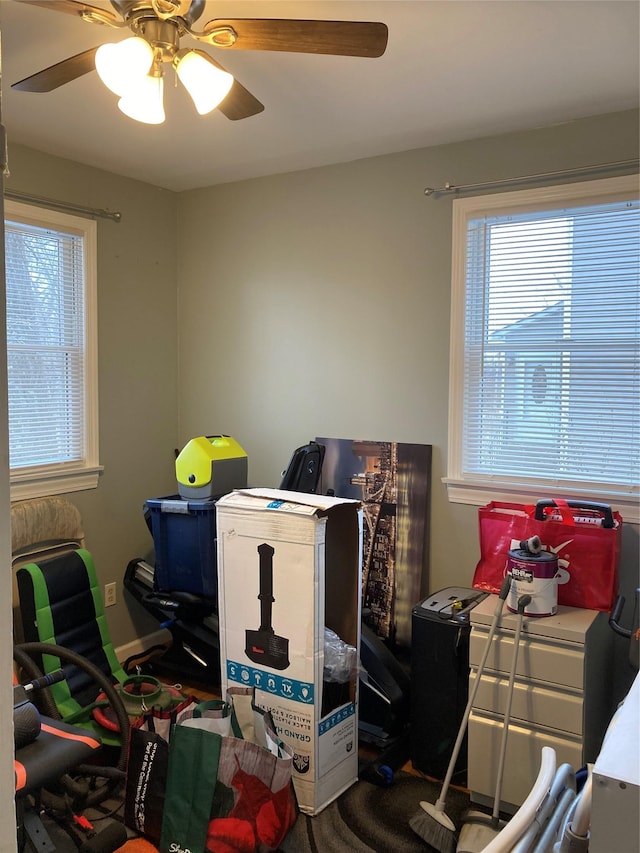 interior space with a ceiling fan and a healthy amount of sunlight