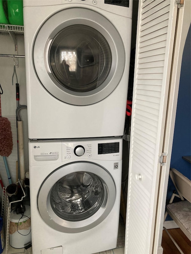 laundry area featuring laundry area and stacked washer / drying machine