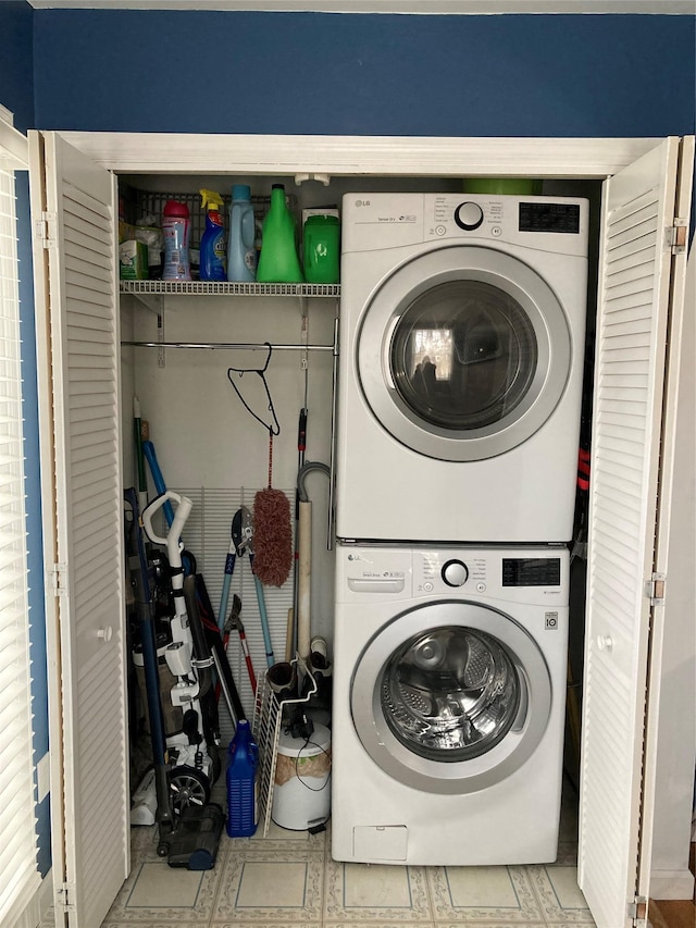 laundry area with stacked washer and dryer and laundry area