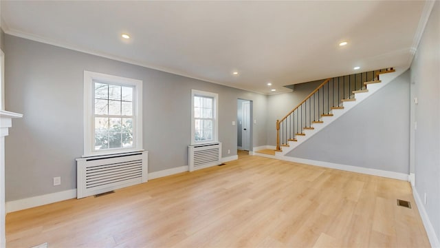 foyer with baseboards, crown molding, light wood finished floors, and stairs