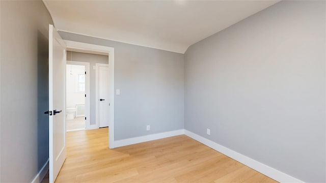 unfurnished room with light wood finished floors and baseboards