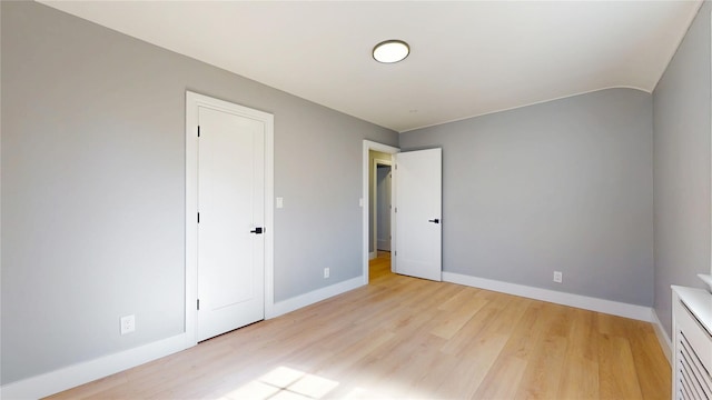 spare room with light wood-style flooring and baseboards