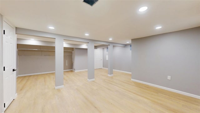 finished below grade area featuring recessed lighting, light wood-style flooring, and baseboards