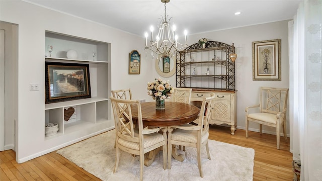 5225 Peconic Bay Blvd, Laurel, NY 11948 - dining room with baseboards, crown molding, a chandelier, and light wood-style floors