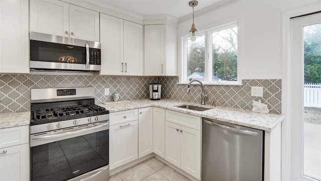 5225 Peconic Bay Blvd, Laurel, NY 11948 - kitchen with light tile patterned floors, tasteful backsplash, light stone countertops, stainless steel appliances, and a sink