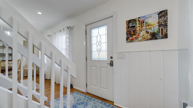 5225 Peconic Bay Blvd, Laurel, NY 11948 - foyer entrance with light wood-type flooring, stairway, and wainscoting