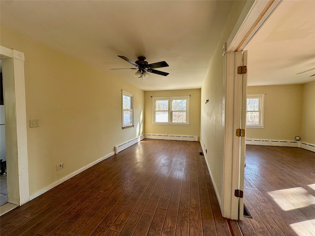 unfurnished room featuring dark wood-style floors, a ceiling fan, and baseboards