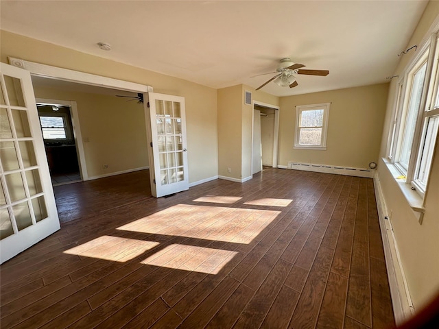 empty room with a baseboard heating unit, french doors, dark wood finished floors, and a ceiling fan