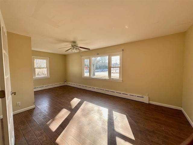 unfurnished room featuring baseboards, a baseboard heating unit, and dark wood finished floors