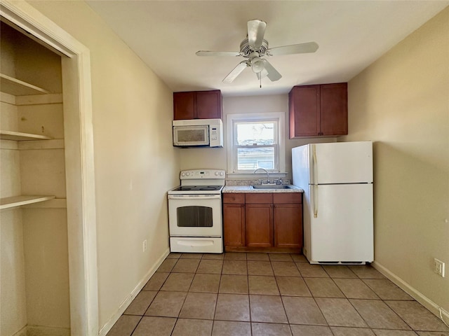 kitchen featuring ceiling fan, white appliances, a sink, baseboards, and light countertops