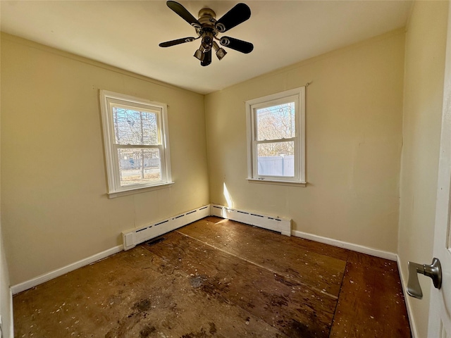 spare room with ceiling fan, baseboard heating, plenty of natural light, and baseboards