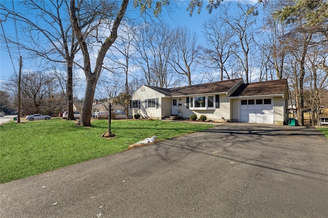 view of front of home with aphalt driveway, an attached garage, and a front lawn