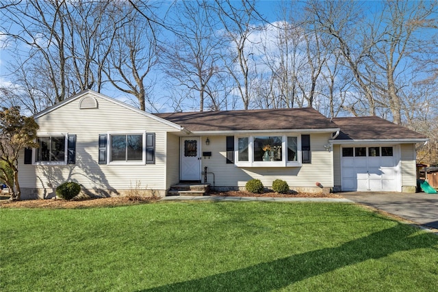 ranch-style house featuring a garage, driveway, and a front yard