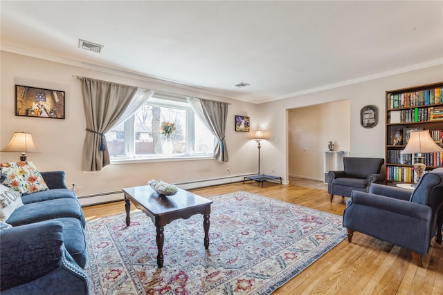 living room featuring a baseboard heating unit, ornamental molding, and light wood-style floors