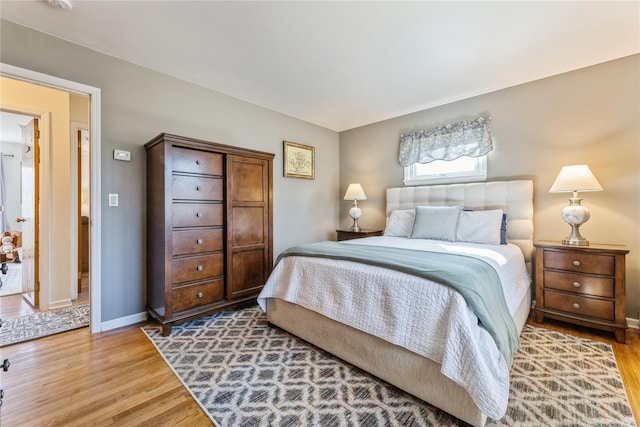 bedroom featuring light wood-type flooring and baseboards