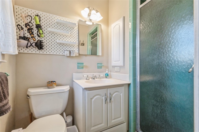 full bath featuring vanity, a shower stall, and toilet