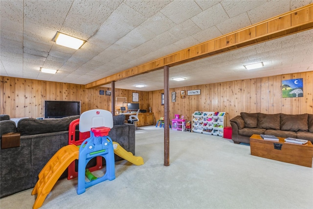 game room with carpet and wood walls