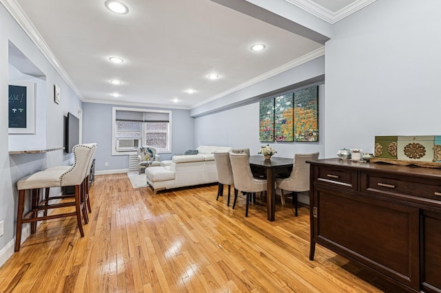 living area with ornamental molding, recessed lighting, light wood-style flooring, and baseboards