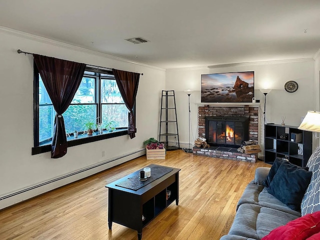 living area with visible vents, wood finished floors, crown molding, a brick fireplace, and a baseboard heating unit