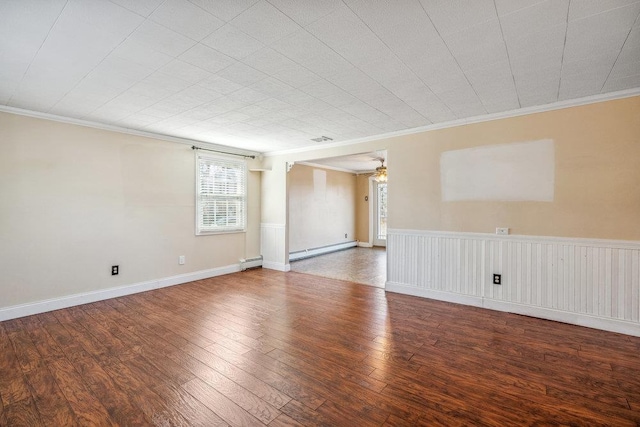 empty room featuring a wainscoted wall, a baseboard radiator, wood-type flooring, ornamental molding, and baseboard heating