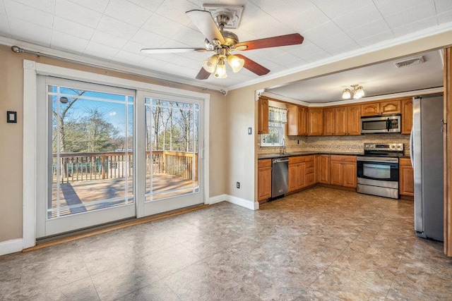 kitchen with stainless steel appliances, brown cabinetry, visible vents, and crown molding