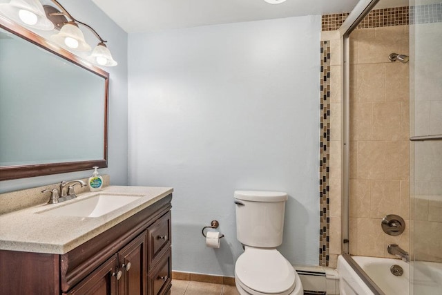 bathroom with toilet, a baseboard radiator, enclosed tub / shower combo, tile patterned floors, and vanity