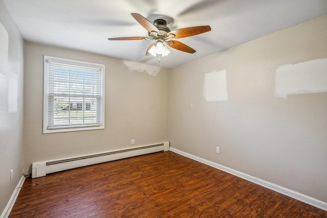 empty room featuring baseboards, baseboard heating, and wood finished floors