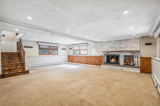 unfurnished living room featuring carpet, a baseboard radiator, and a fireplace