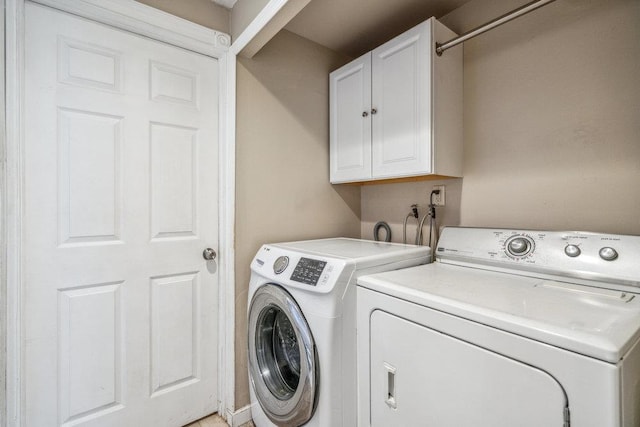 laundry area with cabinet space and separate washer and dryer